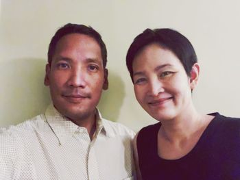 Portrait of smiling young couple against white background