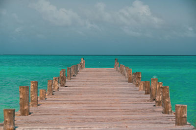 Pier over sea against sky