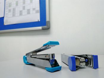 Close-up of staplers on table