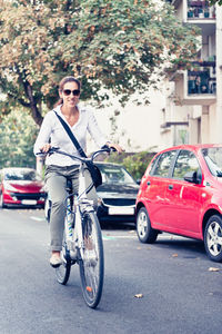 Woman riding bicycle on road