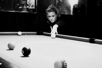 Portrait of boy playing with ball at table