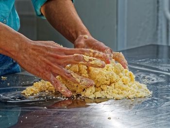 Close-up of man preparing food in kitchen counter