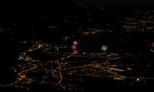 High angle view of city lit up at night