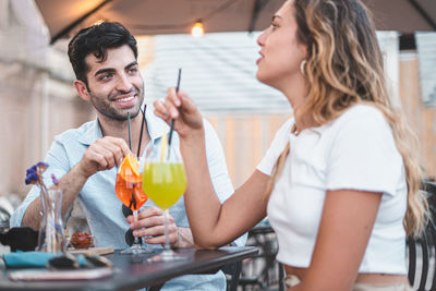 Young man and woman sitting at restaurant