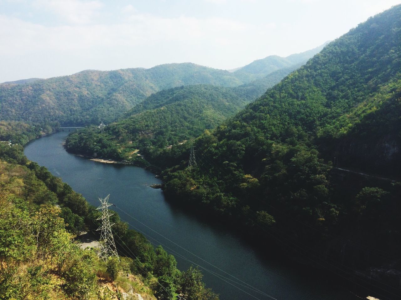 mountain, tranquil scene, tranquility, scenics, beauty in nature, water, tree, mountain range, nature, green color, sky, landscape, non-urban scene, idyllic, growth, lush foliage, lake, river, high angle view, day