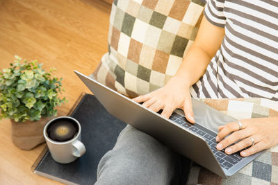 High angle view of man using laptop on table