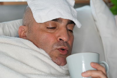 Sick man having coffee at home