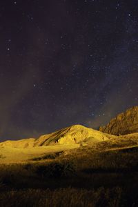 Low angle view of pyrenees against star field at night