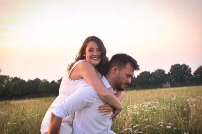 Portrait of woman piggyback on man