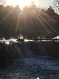 Scenic view of waterfall against sky