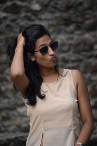 Young woman wearing sunglasses standing outdoors