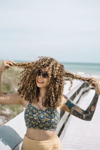 Woman standing on pier at beach