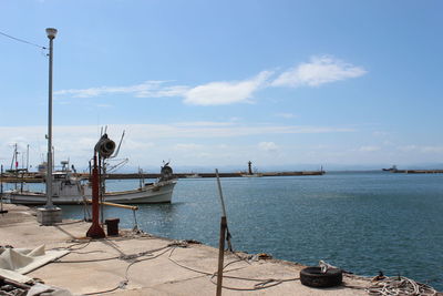 View of boats in sea against cloudy sky
