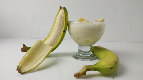 Close-up of fruits on table against white background