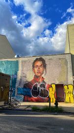 Portrait of man with umbrella on road against sky