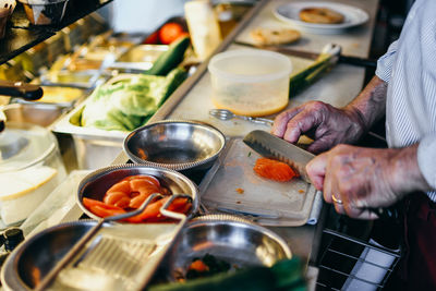 Midsection of man preparing food in kitchen