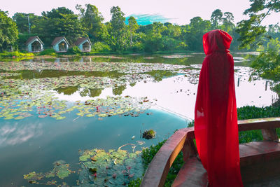 Reflection of man on red water in lake