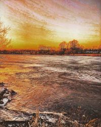 Scenic view of snow covered landscape during sunset