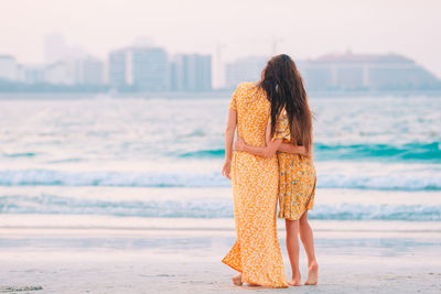 Rear view of woman standing on beach