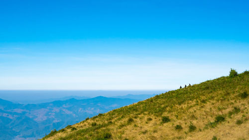 Scenic view of mountains against blue sky