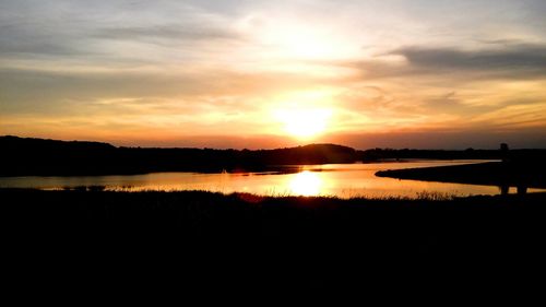 Scenic view of lake at sunset