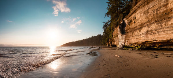 Scenic view of beach against sky during sunset