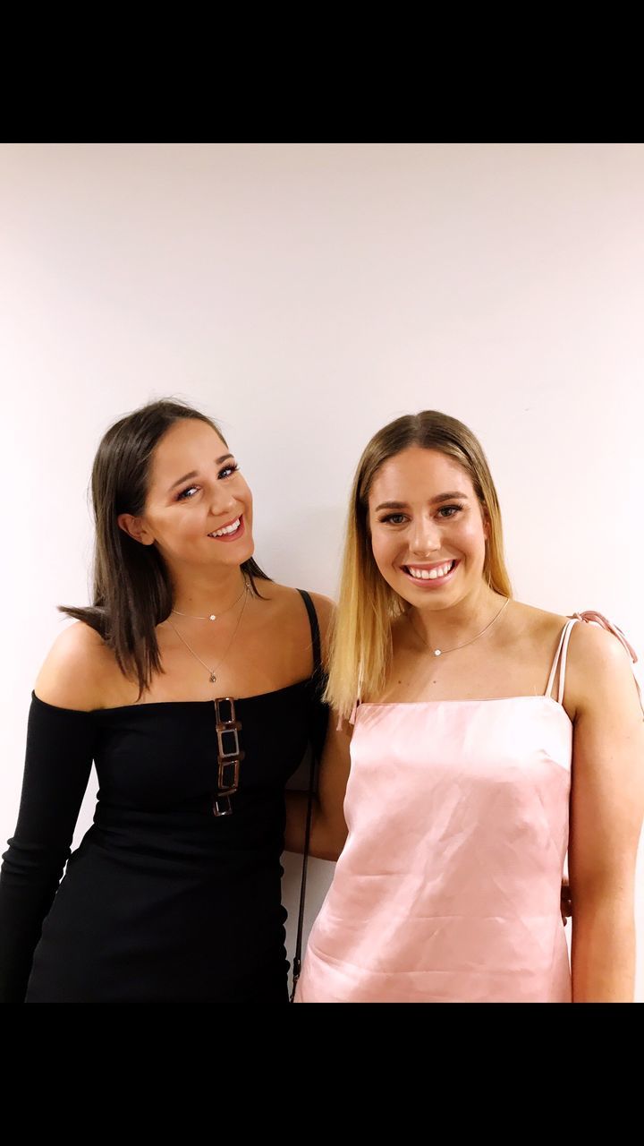 two people, smiling, real people, young women, studio shot, happiness, long hair, young adult, looking at camera, leisure activity, lifestyles, friendship, portrait, beautiful woman, standing, white background, togetherness, indoors, day