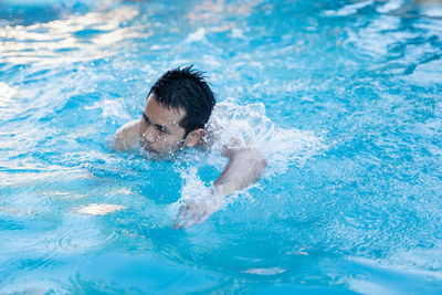 Man swimming in pool