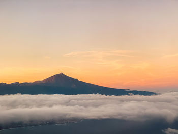 Aerial view of volcano peak against sky during sunrise
