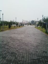 Cobblestone street against clear sky