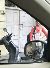 Man standing by car window