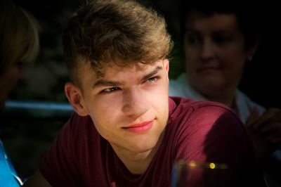 Close-up of teenage boy looking away