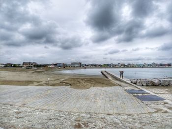 Pier over city against sky