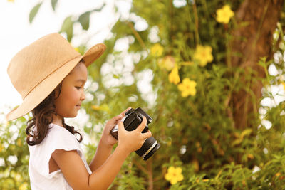 Side view of a girl wearing hat