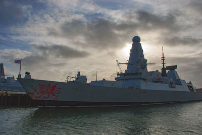 Ship moored in sea against sky