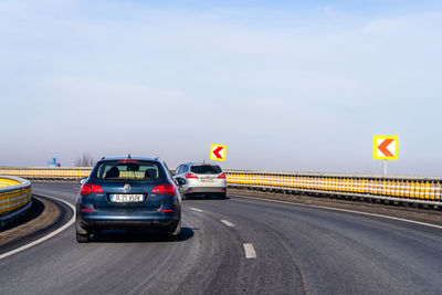 Cars on road against sky