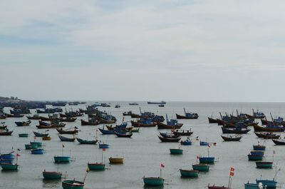 High angle view of boats moored in sea against sky