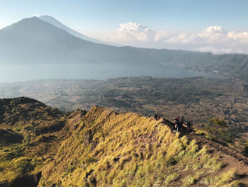 High angle view of people on mountain against sky