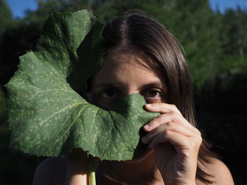 Close-up of woman holding leaf