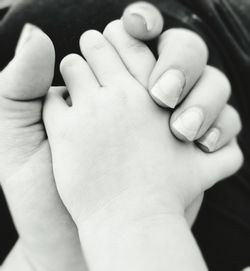 Close-up of hand holding baby