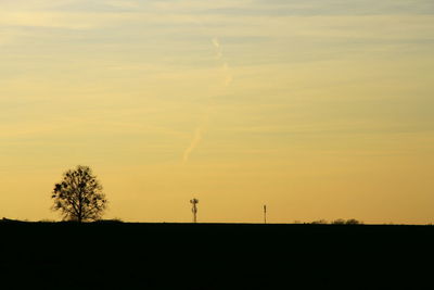 Scenic view of silhouette field against sky during sunset