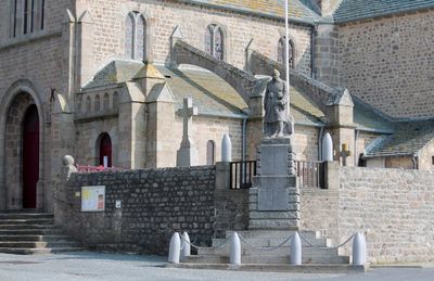 Statue against cropped church