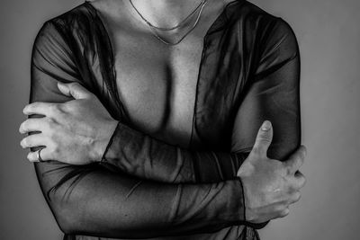 Close-up of man wearing mask against white background