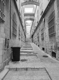 Empty alley amidst buildings in city