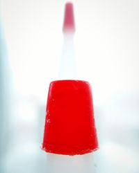 Close-up of red ice cream against white background