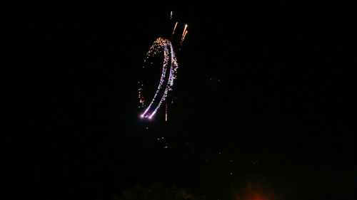 Low angle view of firework display at night