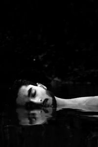 Portrait of young man swimming in pool