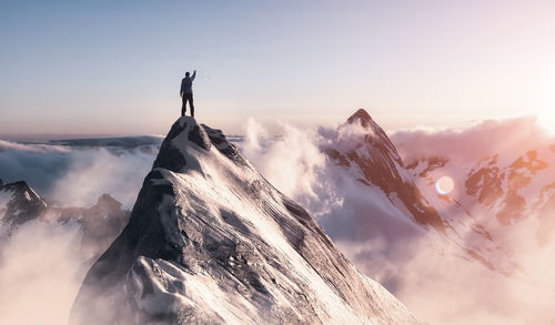 Scenic view of snowcapped mountains against sky during sunset