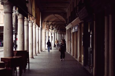 People walking in corridor of building