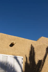 Low angle view of building against blue sky